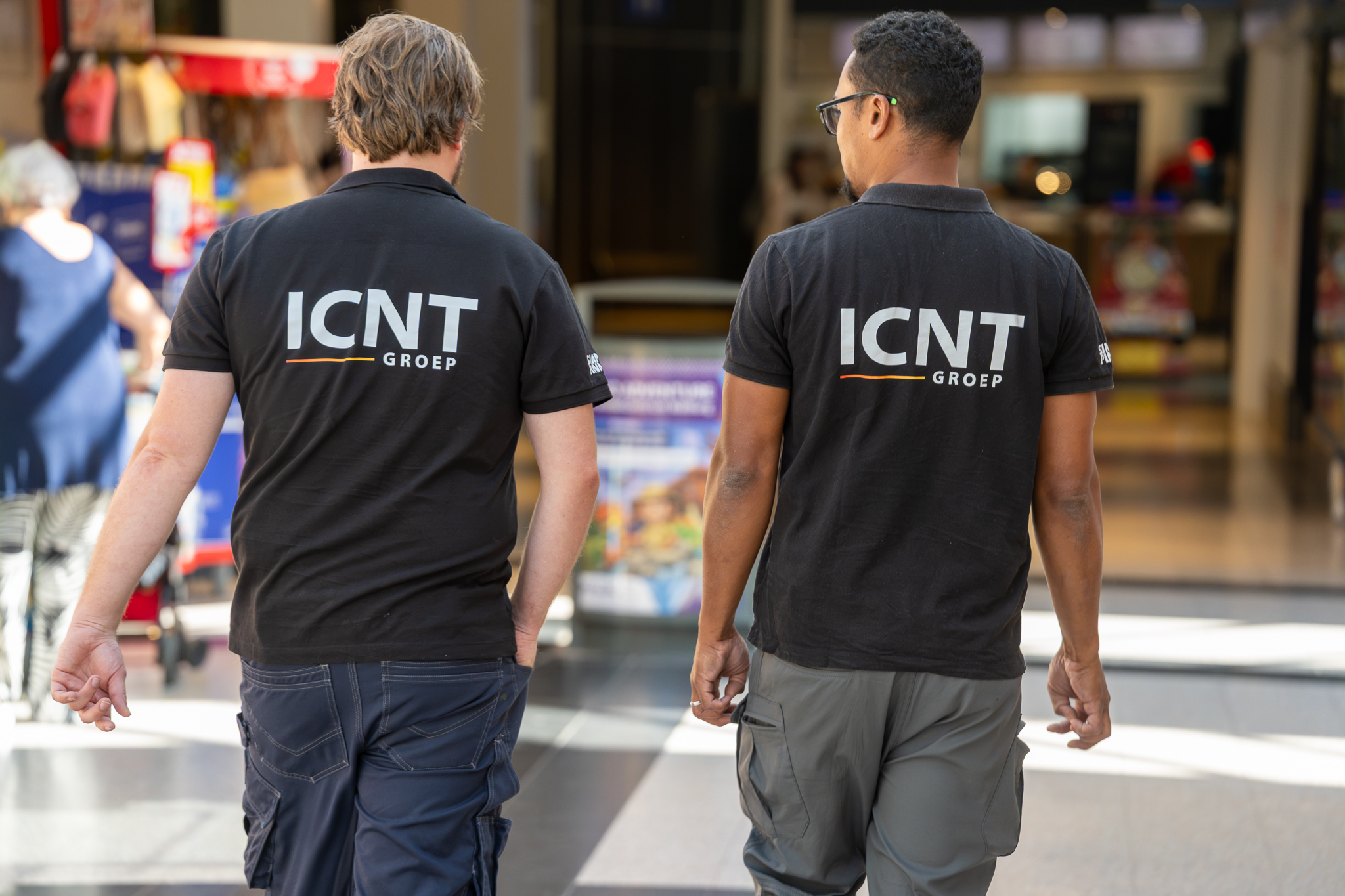 Two ICNT technicians walking through a client's retail building