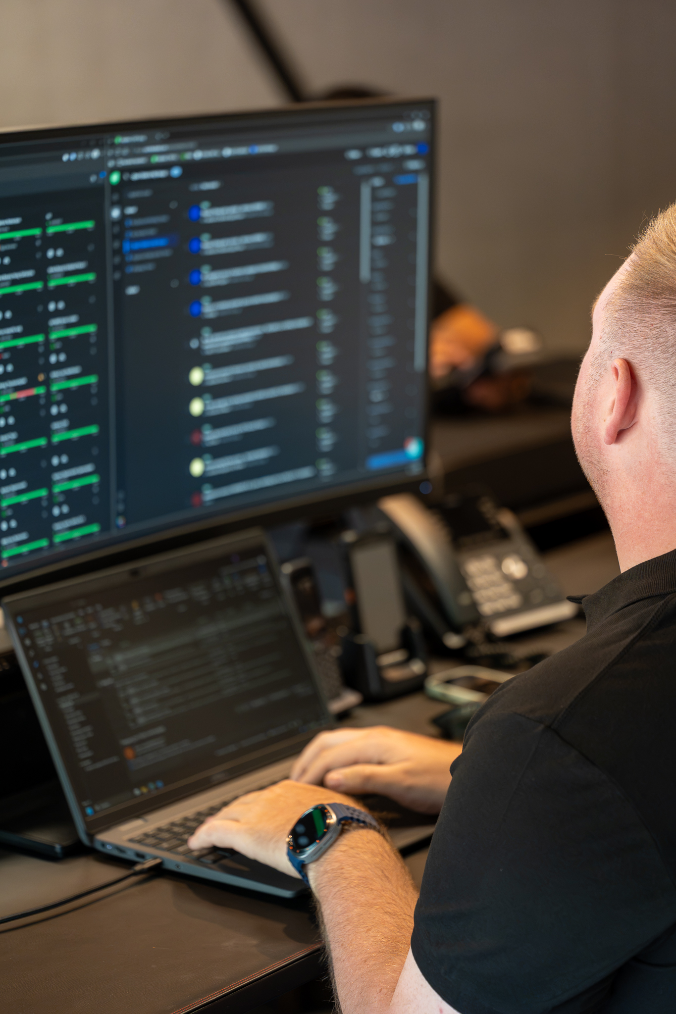 ICNT engineer working across two monitors on a live support case