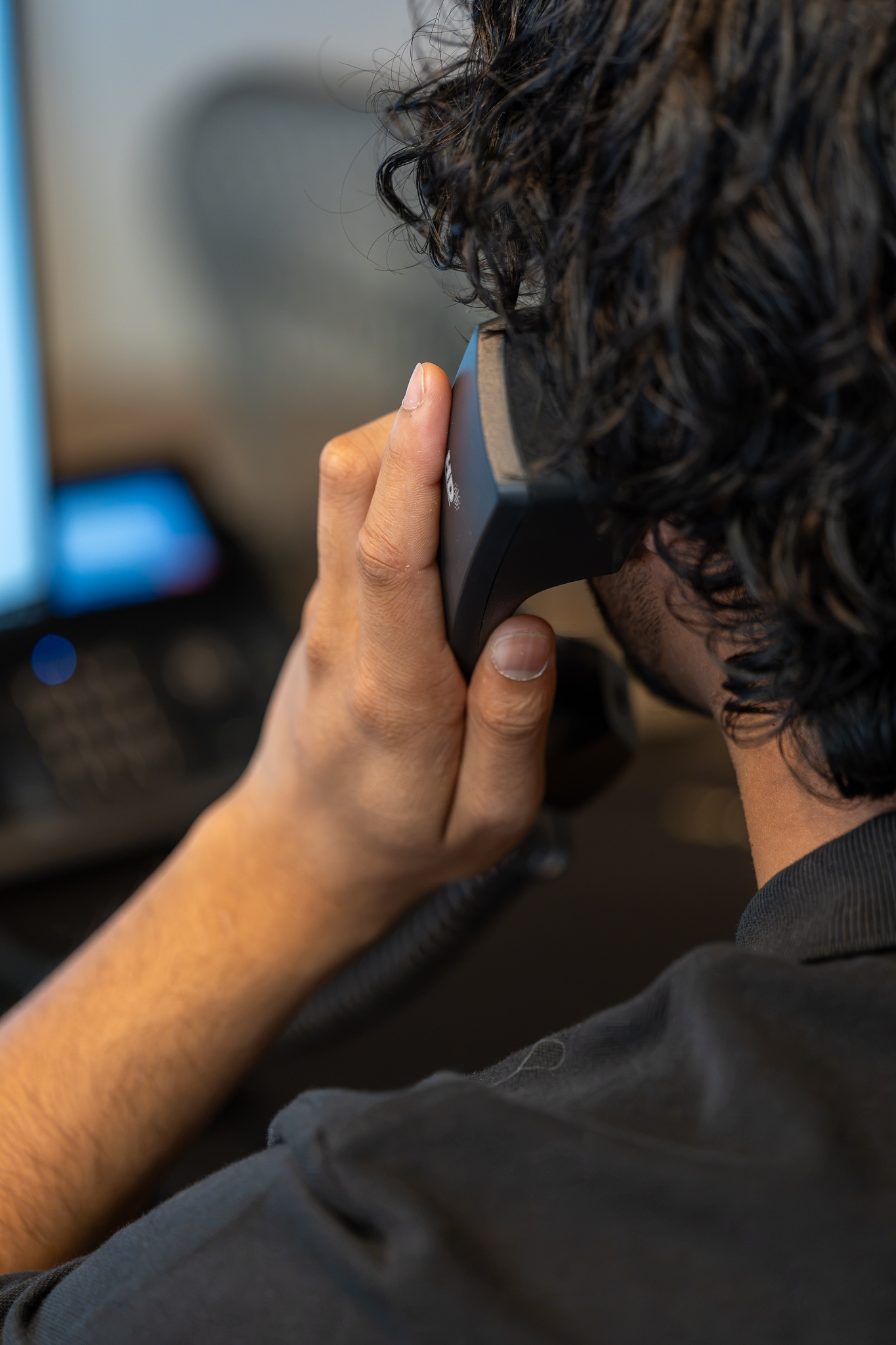 Employee taking a call on a business desk phone
