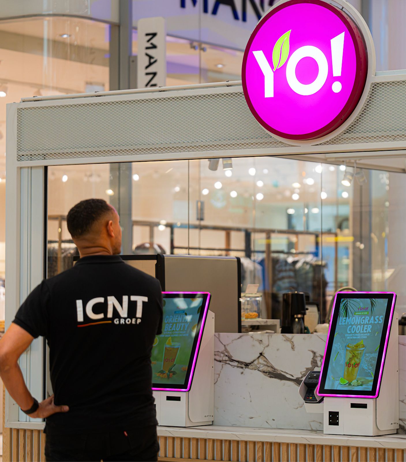 ICNT engineer standing at a Yo! Sushi self-order kiosk installation
