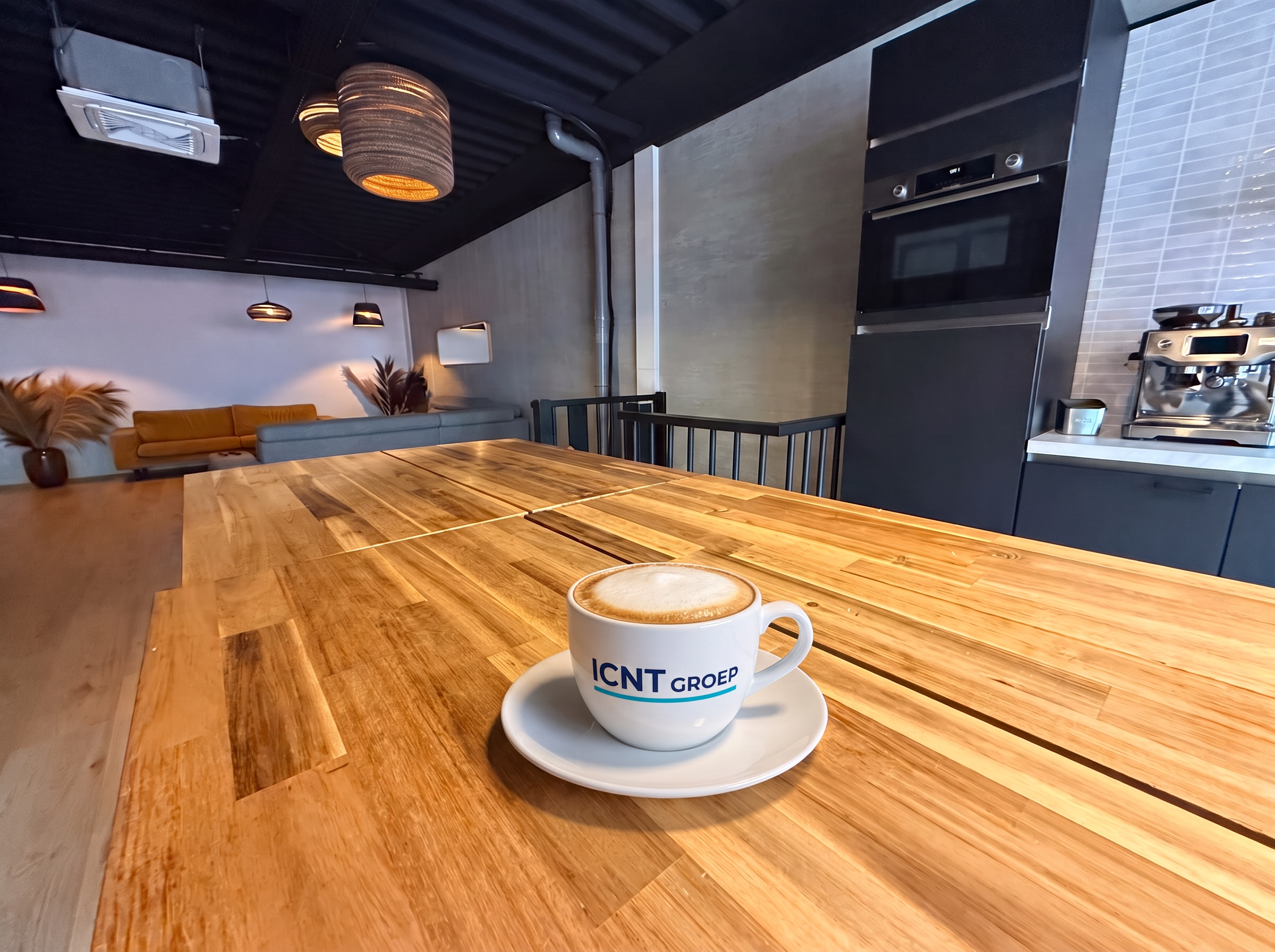 ICNT office meeting table with a branded cappuccino cup